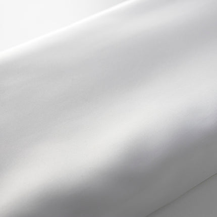 Close-up of a textured white surface with light reflections