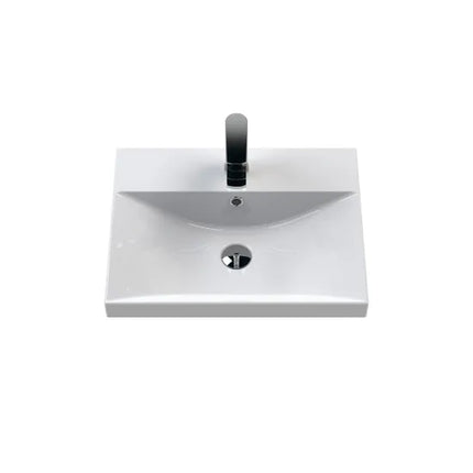 White rectangular sink with black faucet on a white background