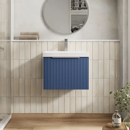 Bathroom with a blue striped cabinet and round mirror