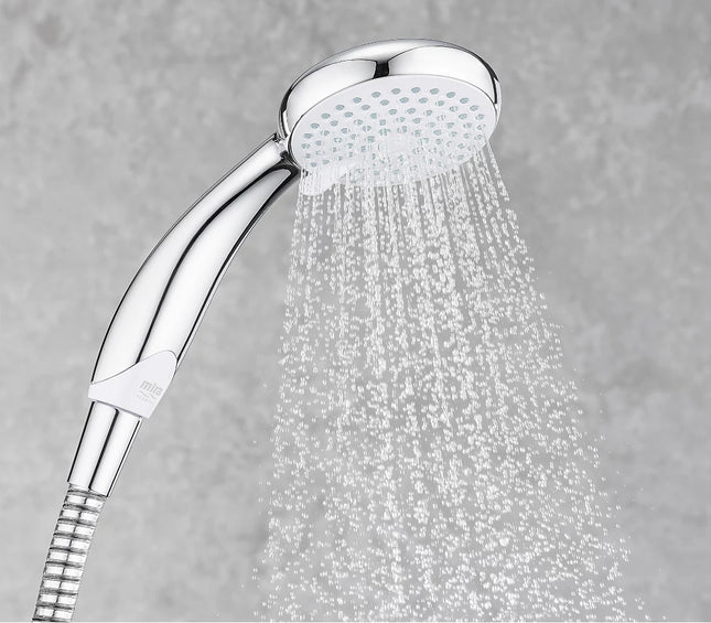 Chrome shower head with water spraying against a gray background