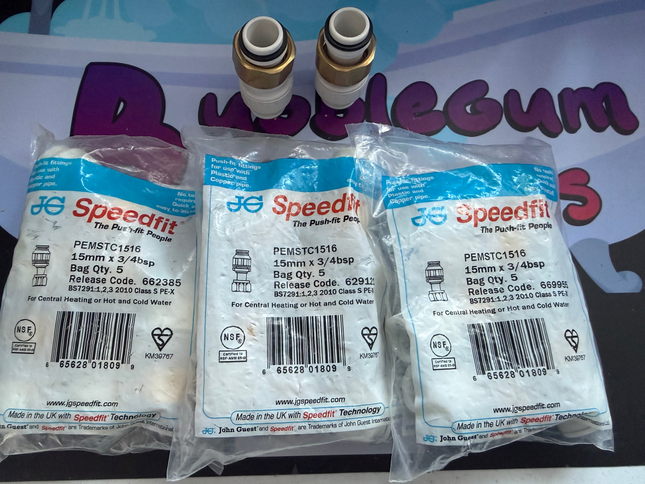 Three packages of Speedfit plumbing fittings on a colorful background