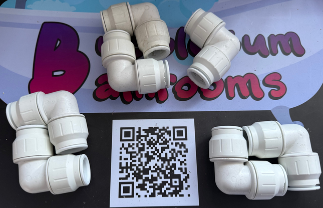 White plastic pipe fittings on a black and blue background with a QR code.