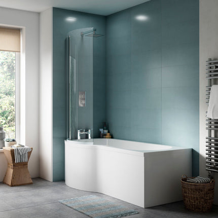Modern bathroom with a white bathtub against a blue tiled wall.