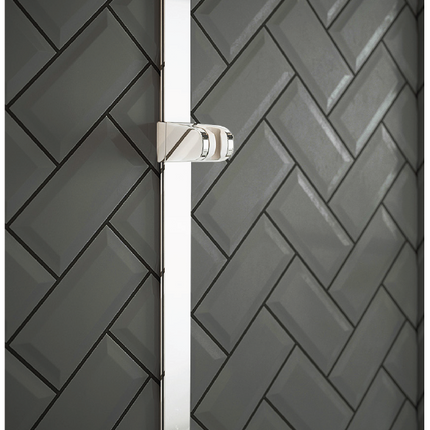 Chrome shower Slide Rail on a black tiled wall with a herringbone pattern