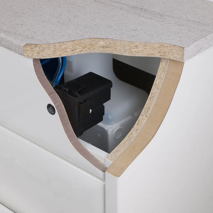 Close-up of a white wc unit with a countertop installed, showing the cutout and backing material of a concealed cistern with senor flush