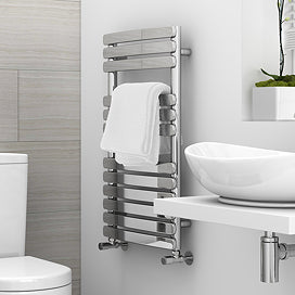 Bathroom setup with a towel radiator, sink, and toilet.